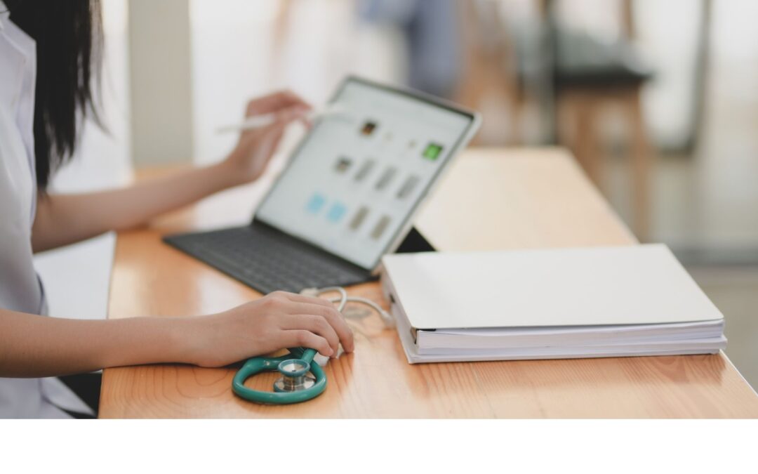 Nurse practitioner using EHR telehealth platform to schedule virtual patient care with a laptop