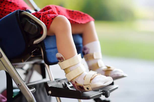 child with cerebral palsy in wheelchair with leg braces waiting for pediatrician telemedicine review on viosapp vios clinic