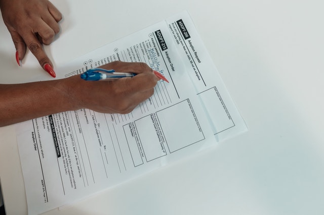 woman completing a healthcare coverage form for pap smear tests covered by medicare in usa