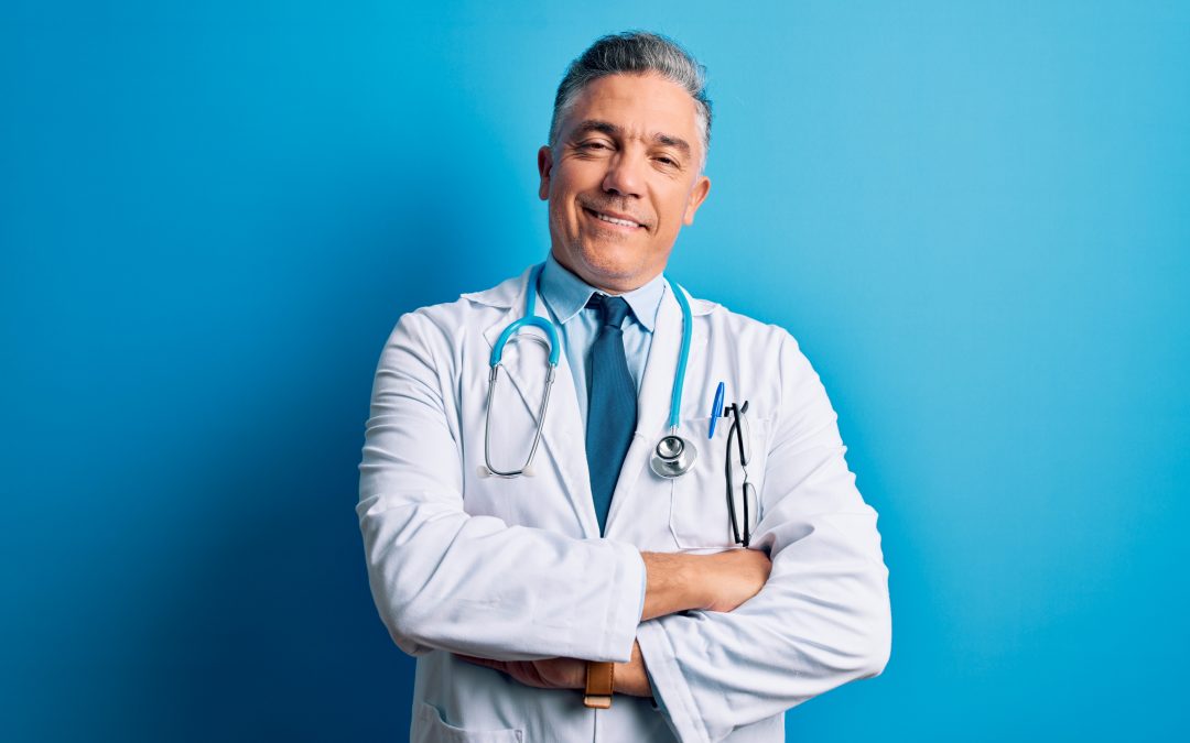 happy doctor with light blue stethoscope and labcoat beside light blue background