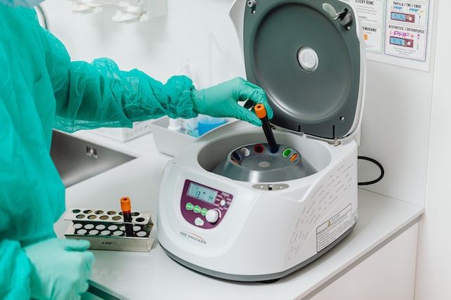lab technician working with blood samples in a centrifuge