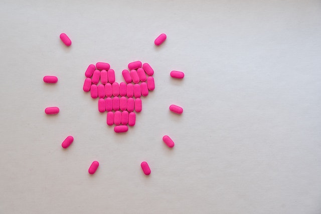 Prescription heart medication pills set up to represent the heart