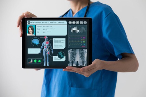 MEdical assistant holding ipad pro with EHR software